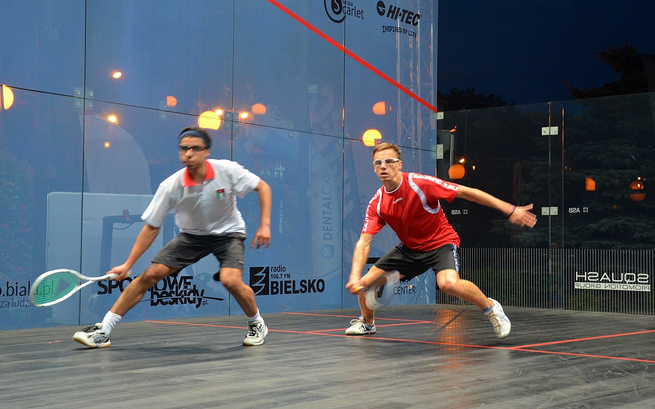 Two players competing in a squash match